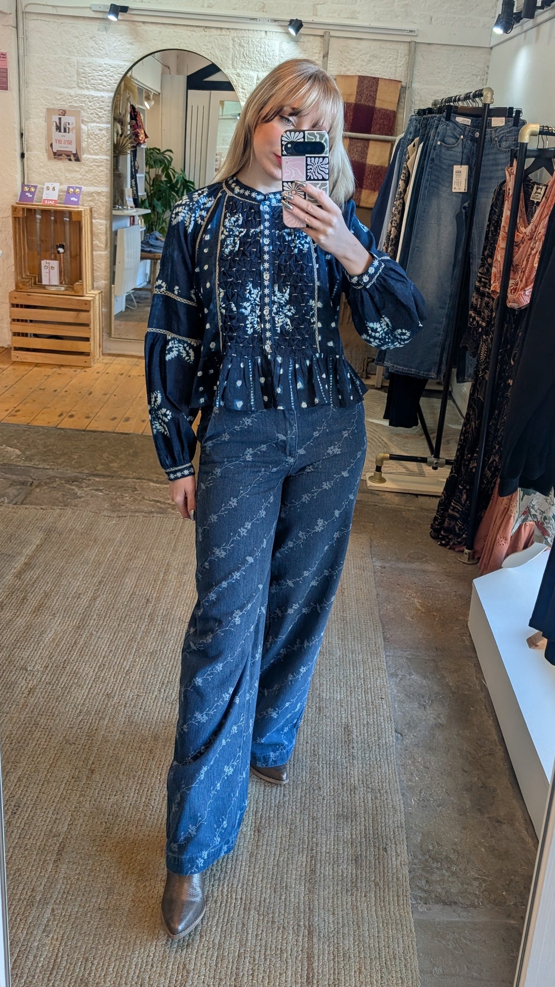 Person taking a mirror selfie wearing a maison hotel blue patterned outfit in Suki's Wardrobe clothing store in Uppermill near Manchester